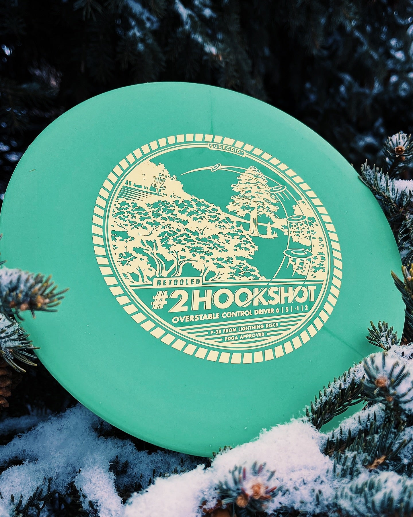Lightning Discs #2 Hookshot in Sure Grip plastic, an overstable midrange disc with a pronounced rim and classic stamp, designed for reliable fade and strong headwind performance.