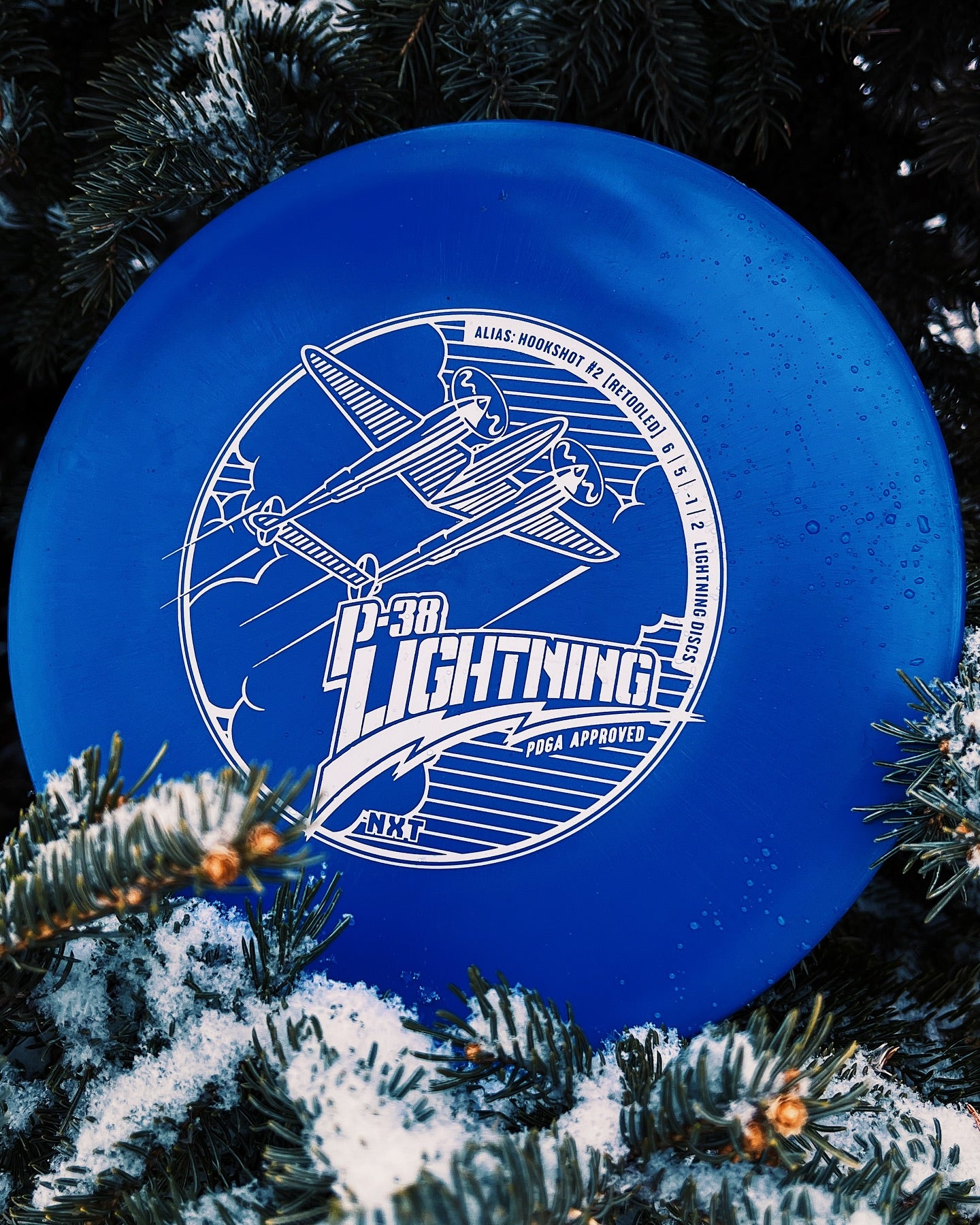 Lightning Discs #2 Hookshot P-38 edition in NXT plastic, an overstable midrange disc with a smooth, slightly flexible feel and military-inspired stamp for controlled fade shots.