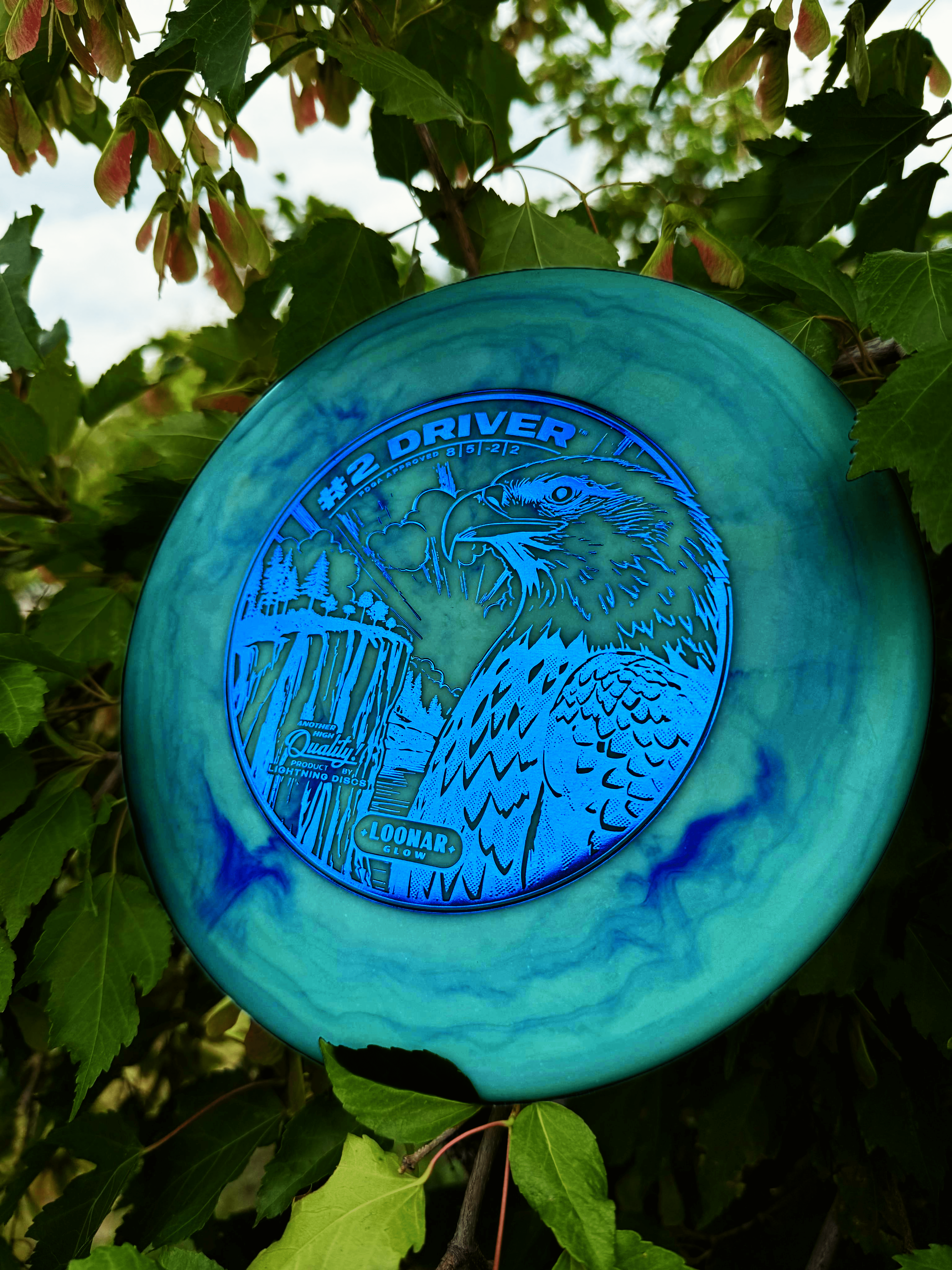 #2 Driver by Lightning Discs, shown in Loonar Glow plastic that glows brightly at night and floats in water, with a durable, grippy feel and ideal for controlled distance shots.